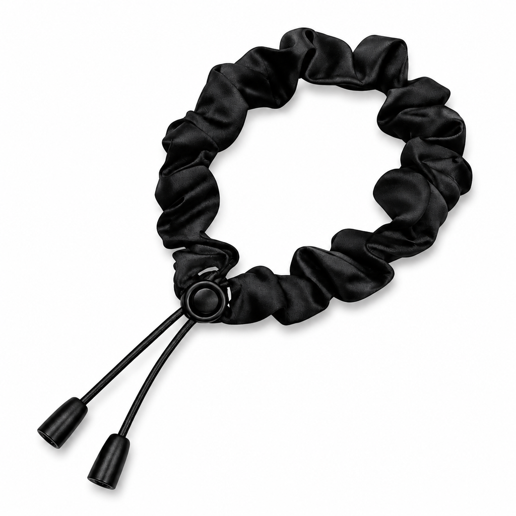 Adjustable black satin scrunchie with a smooth finish and practical design for everyday styling and effortless hair management.