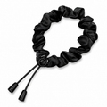 Adjustable black satin scrunchie with a smooth finish and practical design for everyday styling and effortless hair management.